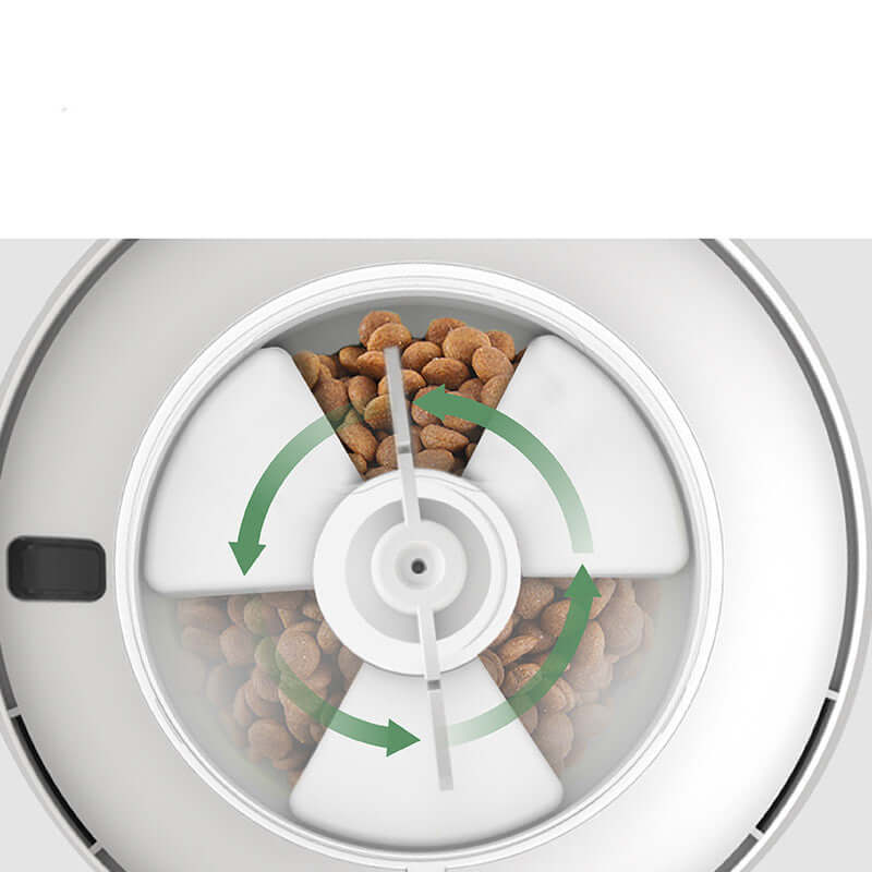 Pet food dispenser with rotating compartment containing dry cat food.